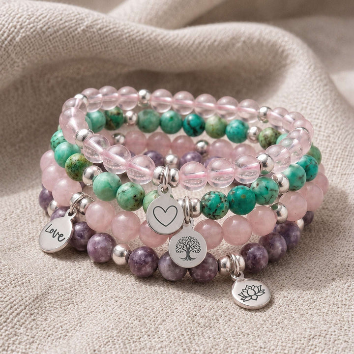 A stack of four personalised crystal gemstone bracelets — AAA Rose Quartz, Chrysocolla, Rose Quartz, and Lepidolite