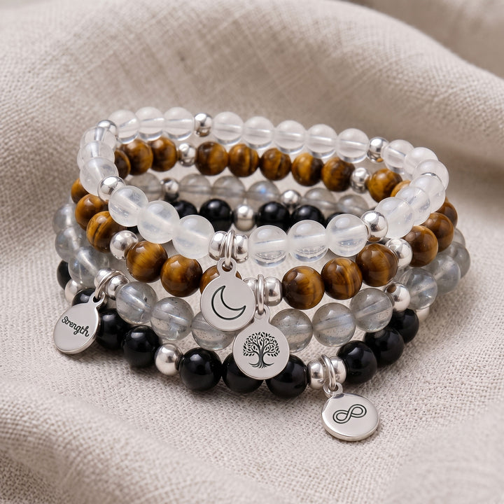 A stack of four personalised crystal gemstone bracelets — Black Tourmaline, Selenite, Tiger&