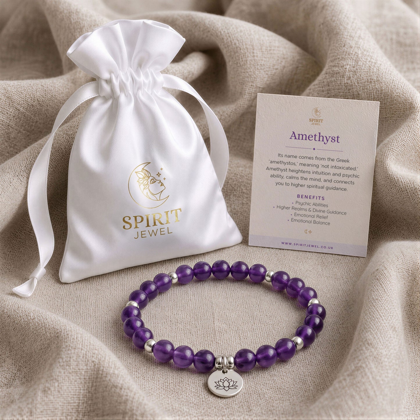 a white satin pouch with a gold logo, a bracelet made of purple beads, and a card with information about the Amethyst gemstone.