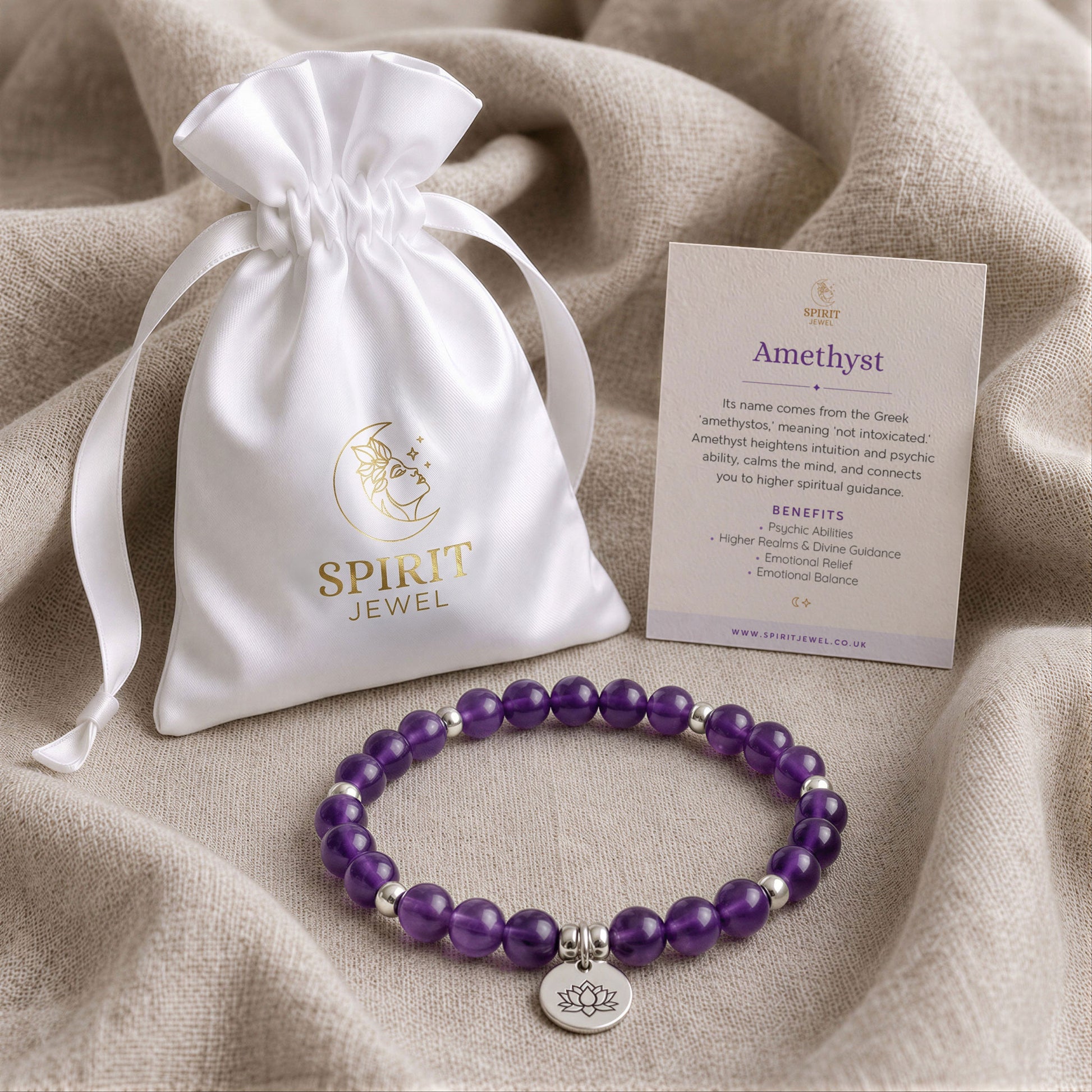 a white satin pouch with a gold logo, a bracelet made of purple beads, and a card with information about the Amethyst gemstone.